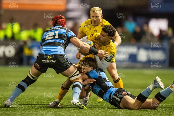 261225 - Cardiff Rugby v Dragons RFC - United Rugby Championship - Rio Dyer of Dragons is tackled by Jacob Beetham of Cardiff Rugby and Liam Botham of Cardiff Rugby