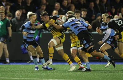 301124 - Cardiff Rugby v Dragons RFC - United Rugby Championship - Taine Basham of Dragons is tackled by Cameron Winnett and Aled Davies of Cardiff 