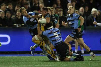 301124 - Cardiff Rugby v Dragons RFC - United Rugby Championship - Taine Basham of Dragons is tackled by Cameron Winnett and Aled Davies of Cardiff 