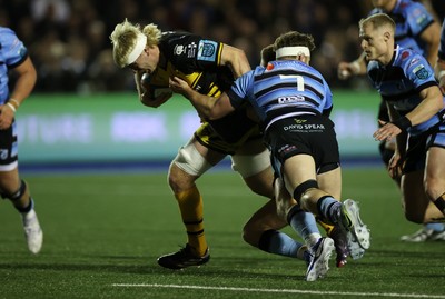 301124 - Cardiff Rugby v Dragons RFC - United Rugby Championship - Aaron Wainwright of Dragons is tackled by Thomas Young of Cardiff 