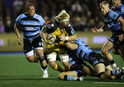 301124 - Cardiff Rugby v Dragons RFC - United Rugby Championship - Aaron Wainwright of Dragons is tackled by Thomas Young of Cardiff 