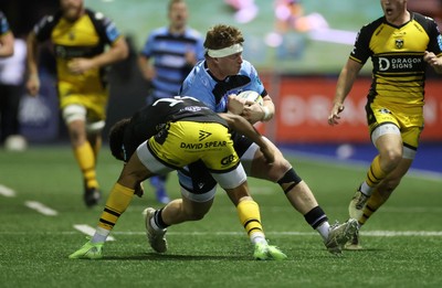 301124 - Cardiff Rugby v Dragons RFC - United Rugby Championship - Evan Lloyd of Cardiff is tackled by Rio Dyer of Dragons 