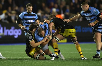 301124 - Cardiff Rugby v Dragons RFC - United Rugby Championship - Corey Domachowski of Cardiff is tackled by Ryan Woodman and Matthew Screech of Dragons 