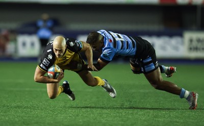 301124 Cardiff Rugby v Dragons RFC, United Rugby Championship - Jared Rosser of Dragons is tackled by Rey Lee-Lo of Cardiff Rugby