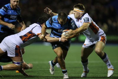 251025 - Cardiff Rugby v Edinburgh - United Rugby Championship - Liam Belcher of Cardiff is tackled by Marshall Sykes and Paul Hill of Edinburgh 