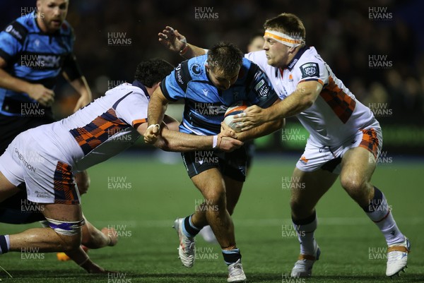 251025 - Cardiff Rugby v Edinburgh - United Rugby Championship - Liam Belcher of Cardiff is tackled by Marshall Sykes and Paul Hill of Edinburgh 