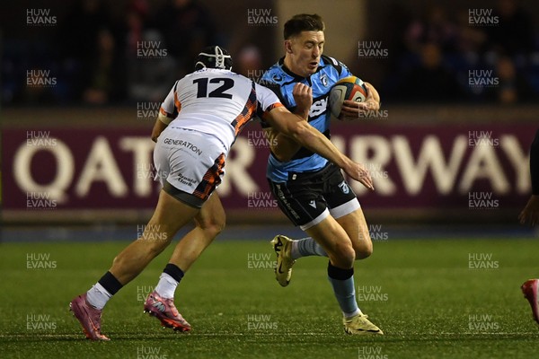 251025 - Cardiff Rugby v Edinburgh Rugby - United Rugby Championship - Josh Adams of Cardiff Rugby is challenged by James Lang of Edinburgh