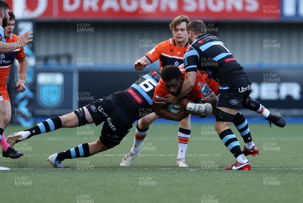301022 - Cardiff Rugby v Edinburgh - BKT United Rugby Championship - Viliame Mata of Edinburgh is tackled by James Botham and Thomas Young of Cardiff