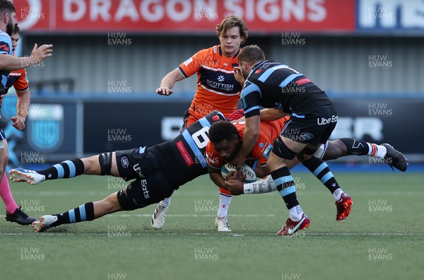 301022 - Cardiff Rugby v Edinburgh - BKT United Rugby Championship - Viliame Mata of Edinburgh is tackled by James Botham and Thomas Young of Cardiff
