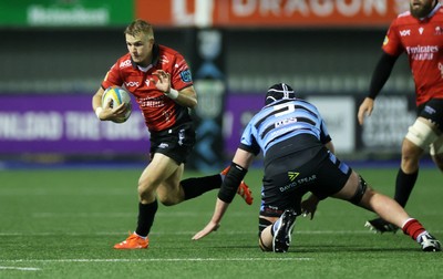 210325 - Cardiff Rugby v Emirates Lions - United Rugby Championship - Nico Steyn of Lions is challenged by Seb Davies of Cardiff 