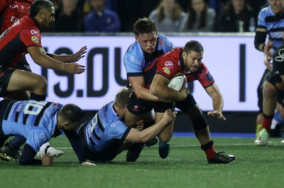 210325 - Cardiff Rugby v Emirates Lions - United Rugby Championship - Marius Louw of Lions is tackled by Johan Mulder and Alex Mann of Cardiff 