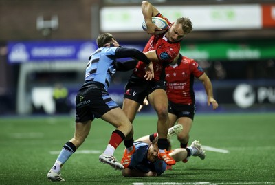 210325 - Cardiff Rugby v Emirates Lions - United Rugby Championship - Richard Kriel of Lions is tackled by Cameron Winnett and Rory Jennings of Cardiff 