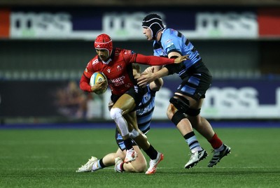 210325 - Cardiff Rugby v Emirates Lions - United Rugby Championship - Edwill van der Merwe of Lions is tackled by Rory Jennings and Seb Davies of Cardiff 