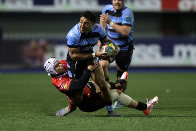 210325 - Cardiff Rugby v Emirates Lions - United Rugby Championship - Gabriel Hamer-Webb of Cardiff is tackled by Henco van Wyk of Lions 