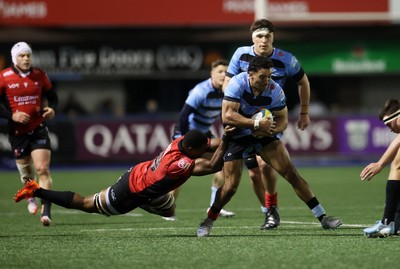 210325 - Cardiff Rugby v Emirates Lions - United Rugby Championship - Gabriel Hamer-Webb of Cardiff is tackled by Siba Qoma of Lions 