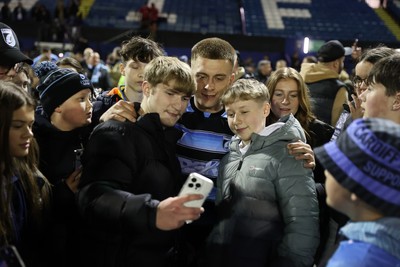 210325 - Cardiff Rugby v Emirates Lions - United Rugby Championship - Cameron Winnett of Cardiff with fans at full time