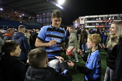 210325 - Cardiff Rugby v Emirates Lions - United Rugby Championship - Teddy Williams of Cardiff with fans at full time