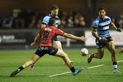 210325 - Cardiff Rugby v Emirates Lions - United Rugby Championship - Rory Jennings of Cardiff is challenged by Marius Louw of Emirates Lions