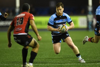 210325 - Cardiff Rugby v Emirates Lions - United Rugby Championship - Rory Jennings of Cardiff is challenged by Manuel Rass of Emirates Lions