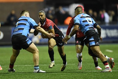 210325 - Cardiff Rugby v Emirates Lions - United Rugby Championship - Darrien Landsberg of Emirates Lions is challenged by Danny Southworth of Cardiff