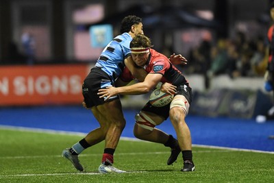 210325 - Cardiff Rugby v Emirates Lions - United Rugby Championship - Jarod Cairns of Emirates Lions is challenged by Gabe Hammer-Webb of Cardiff