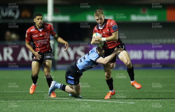 210325 - Cardiff Rugby v Emirates Lions - United Rugby Championship - Nico Steyn of Lions is tackled by Rory Jennings of Cardiff 