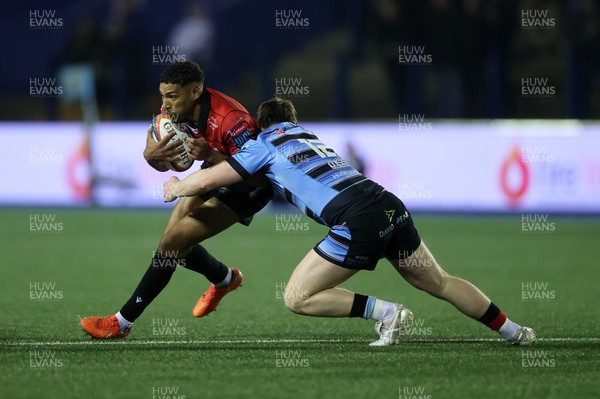 210325 - Cardiff Rugby v Emirates Lions - United Rugby Championship - Gianni Lombard of Lions is tackled by Rory Jennings of Cardiff