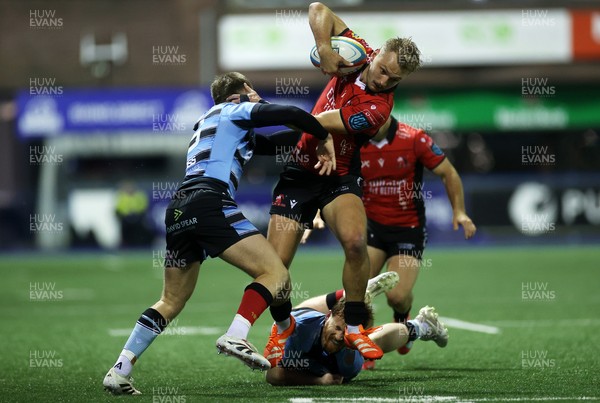 210325 - Cardiff Rugby v Emirates Lions - United Rugby Championship - Richard Kriel of Lions is tackled by Cameron Winnett and Rory Jennings of Cardiff 