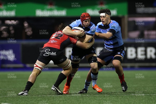 210325 - Cardiff Rugby v Emirates Lions - United Rugby Championship - James Botham of Cardiff is tackled by Jarod Cairns of Lions 