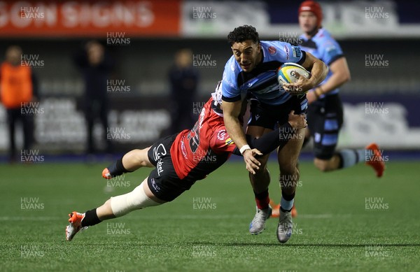 210325 - Cardiff Rugby v Emirates Lions - United Rugby Championship - Gabriel Hamer-Webb of Cardiff is tackled by Henco van Wyk of Lions 