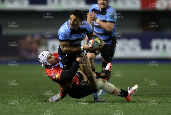 210325 - Cardiff Rugby v Emirates Lions - United Rugby Championship - Gabriel Hamer-Webb of Cardiff is tackled by Henco van Wyk of Lions 