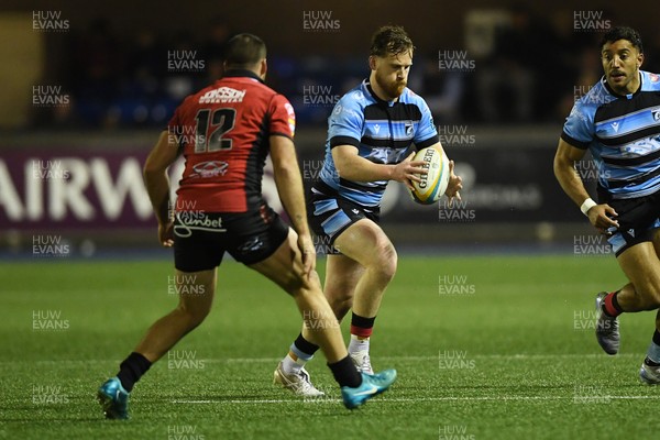 210325 - Cardiff Rugby v Emirates Lions - United Rugby Championship - Rory Jennings of Cardiff is challenged by Marius Louw of Emirates Lions