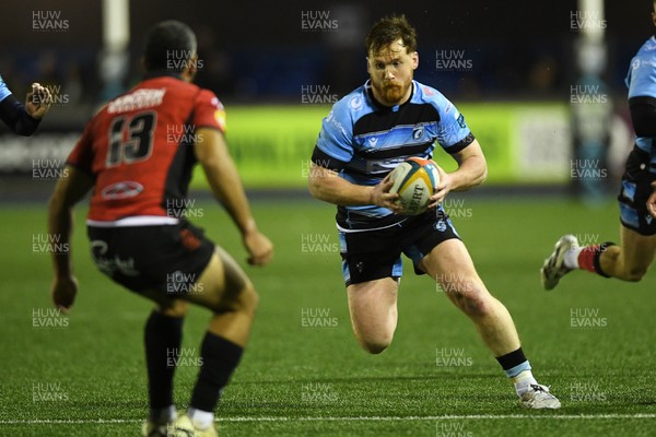 210325 - Cardiff Rugby v Emirates Lions - United Rugby Championship - Rory Jennings of Cardiff is challenged by Manuel Rass of Emirates Lions