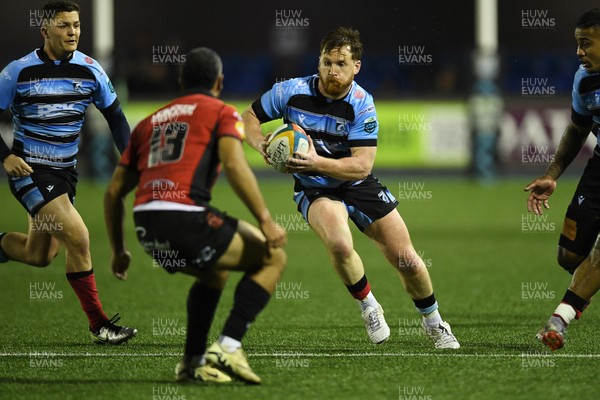 210325 - Cardiff Rugby v Emirates Lions - United Rugby Championship - Rory Jennings of Cardiff is challenged by Manuel Rass of Emirates Lions