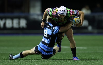270925 - Cardiff Rugby v Emirates Lions - United Rugby Championship - Henco van Wyk of Lions is tackled by Johan Mulder of Cardiff 