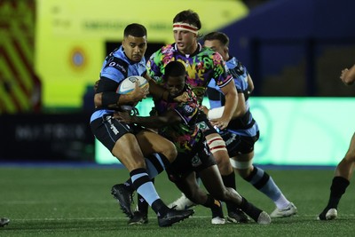 270925 - Cardiff Rugby v Emirates Lions - United Rugby Championship - Ben Thomas of Cardiff is tackled by Lubabalo Dobela of Lions 