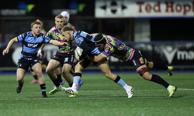 270925 - Cardiff Rugby v Emirates Lions - United Rugby Championship - Cameron Winnett of Cardiff is tackled by Dylan Sjoblom of Lions 