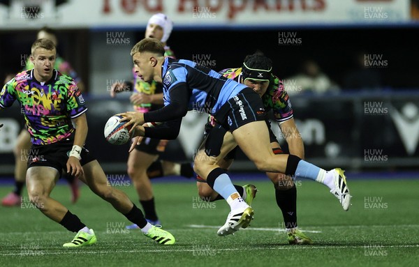 270925 - Cardiff Rugby v Emirates Lions - United Rugby Championship - Cameron Winnett of Cardiff is tackled by Dylan Sjoblom of Lions 