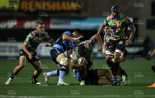 270925 - Cardiff Rugby v Emirates Lions - United Rugby Championship - Asenathi Ntlabakanye of Lions is tackled by Liam Belcher of Cardiff 