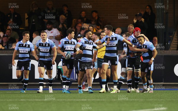 260322 - Cardiff Rugby v Glasgow Warriors - United Rugby Championship - Theo Cabango of Cardiff Rugby celebrates scoring a try with team mates