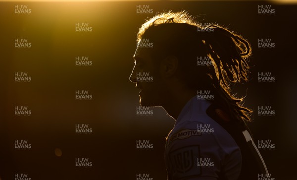 260322 - Cardiff Rugby v Glasgow Warriors, United Rugby Championship - Josh Navidi of Cardiff Rugby is silhouetted against the setting sun during the match