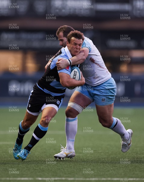 260322 - Cardiff Rugby v Glasgow Warriors, United Rugby Championship - Jarrod Evans of Cardiff Rugby is tackled by Fraser Brown of Glasgow Warriors