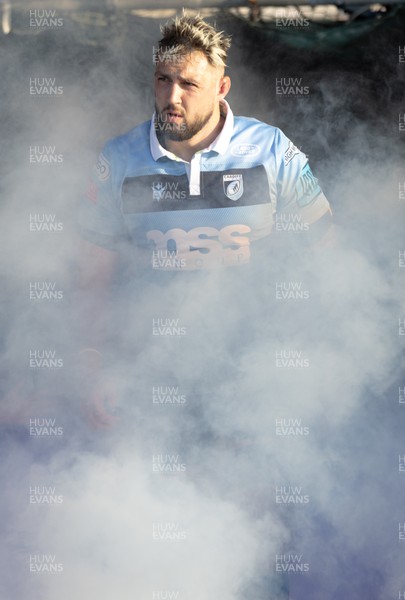 260322 - Cardiff Rugby v Glasgow Warriors, United Rugby Championship - Josh Turnbull of Cardiff Rugby emerges from the smoke as he leads Cardiff Rugby out onto the pitch