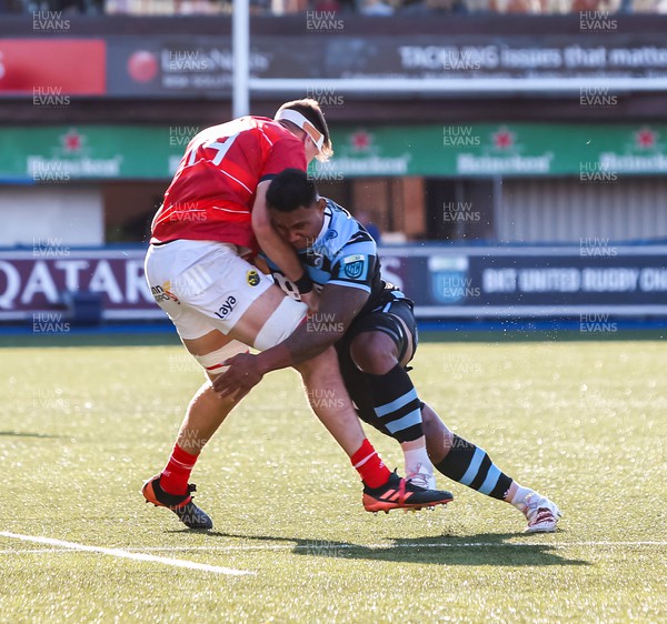 170922 - Cardiff Rugby v Munster - United Rugby Championship - Thomas Ahern of Munster is tackled by Ray Lee-Lo of Cardiff