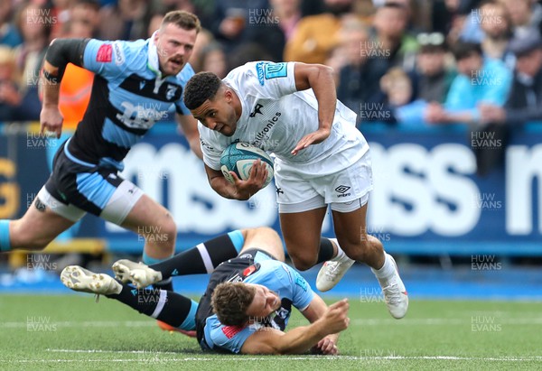 230422 - Cardiff Rugby v Ospreys - United Rugby Championship - Keelan Giles of Ospreys is tackled by Hallam Amos of Cardiff Rugby