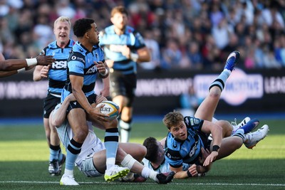 240426 - Cardiff Rugby v Ospreys - United Rugby Championship - Ben Thomas of Cardiff Rugby is challenged by Keiran Williams of Ospreys