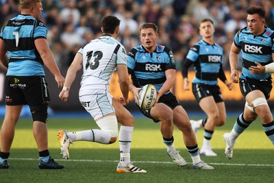 240426 - Cardiff Rugby v Ospreys - United Rugby Championship - Daf Huughes of Cardiff Rugby is challenged by Owen Watkin of Ospreys