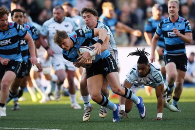 240426 - Cardiff Rugby v Ospreys - United Rugby Championship - Jacob Beetham of Cardiff Rugby is challenged by Dan Edwards of Ospreys
