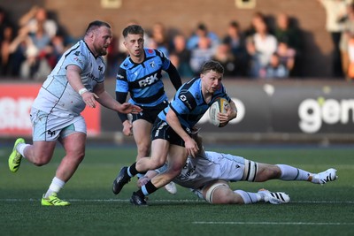 240426 - Cardiff Rugby v Ospreys - United Rugby Championship - Tom Bowen of Cardiff Rugby is challenged by Steffan Thomas of Ospreys