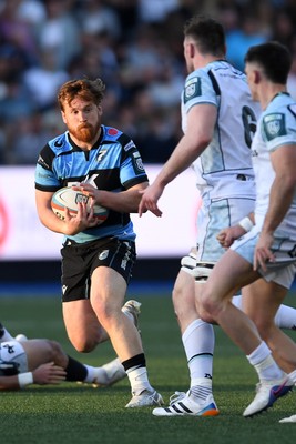 240426 - Cardiff Rugby v Ospreys - United Rugby Championship - Rory Thornton of Cardiff Rugby is challenged by James Ratti of Ospreys